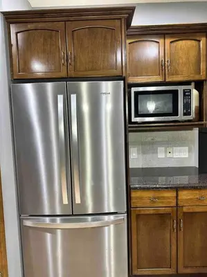 a kitchen with a stainless steel refrigerator and a microwave at Spacious, 2-story Family-Friendly home in Calgary