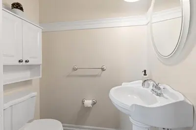 a white bathroom with a sink and a mirror at Grand English Style Home in Chilliwack