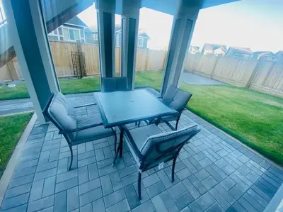 a patio with a table and chairs on a porch at The Royal Bay Escape: Cozy 2 bedrooms garden suite in Colwood