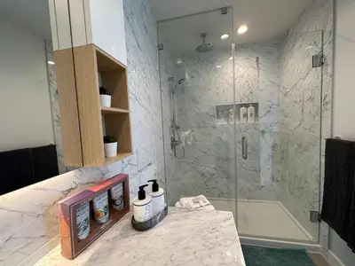 a bathroom with a shower with a glass door at Pacific Sweet Place @Metro in Burnaby