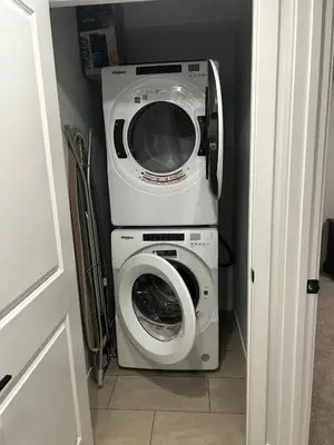 a washing machine and a washer in a room at Praise bethel -Homely walkout legal basement in YYC in Calgary