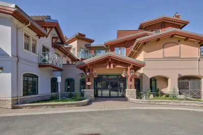 a large house with a driveway in front of it at Residences at the Sun Peaks Grand in Sun Peaks