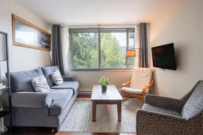 a living room with a couch and a table at The Après Suite in Whistler