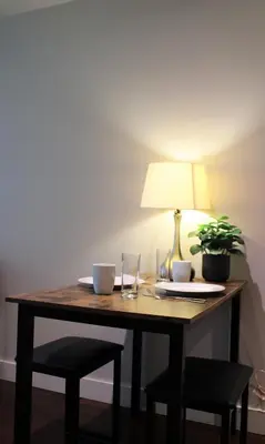 a wooden table with a lamp and a plant on it at The Après Suite in Whistler