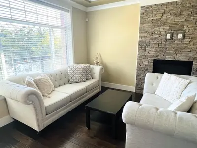 a living room with a couch and a fireplace at Jennifer's House in Vancouver
