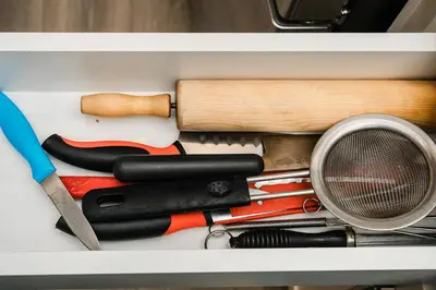 a drawer filled with cooking utensils and a whisk at Modern suite near Airport Hospital Henday Town Ctr in Nisku