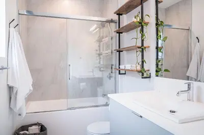 a bathroom with a shower and a sink and a toilet at Glades and Greens by Revelstoke Vacations in Revelstoke
