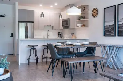 a kitchen and dining room with a table and chairs at Slopes and Greens by Revelstoke Vacations in Revelstoke