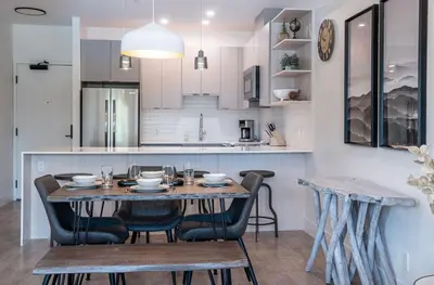 a kitchen and dining room with a table and chairs at Slopes and Greens by Revelstoke Vacations in Revelstoke