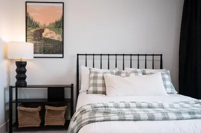 a bedroom with a bed and a picture of a horse at The Selkirk House by Revelstoke Vacations in Revelstoke
