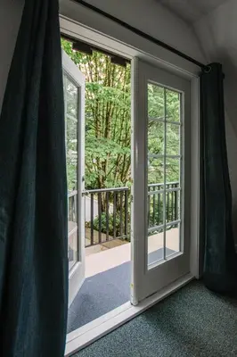 an open door with a view of a balcony at Private Mountainside Home in Chilliwack
