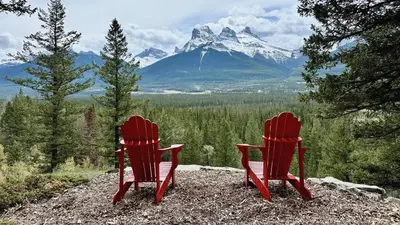 two red chairs sitting on top of a mountain at Canmore Alpine Hostel - Alpine Club of Canada in Canmore
