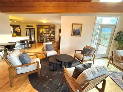 a living room with chairs and a table at Canmore Alpine Hostel - Alpine Club of Canada in Canmore