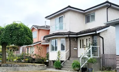 a house with stairs in front of it at Vivi's Home in Vancouver