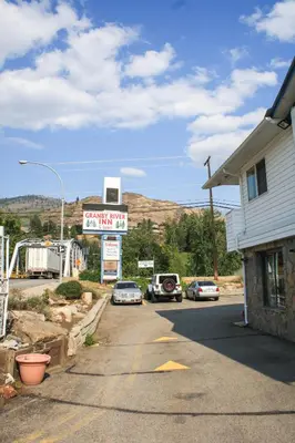 a gas station with cars parked in a parking lot at Granby River Inn & Suites in Grand Forks