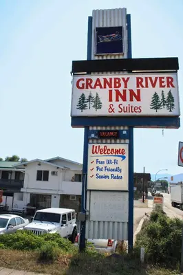 a sign for a cranberry river inn and suites at Granby River Inn & Suites in Grand Forks