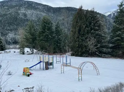 an empty playground in a snow covered field at Stunning 5-bed Retreat in Sunshine Valley in Sunshine Valley