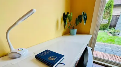a book sitting on a table next to a lamp at Quiet Room in Richmond in Richmond