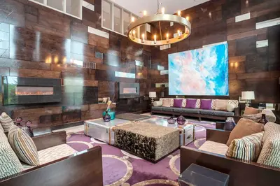 a lobby with wooden walls and couches and a chandelier at Sandman Signature Kamloops Hotel in Kamloops