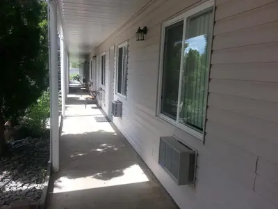 a walkway next to a house with a window at Clearwater Country Inn in Clearwater