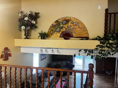 a living room with a fireplace and a shelf at Beautiful room close Airport! in Calgary
