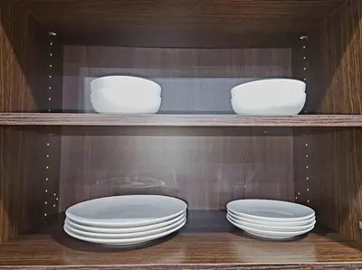 three white bowls and plates on a shelf at Comfort First - sleeps 6 in Whitehorse