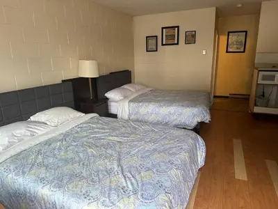 a hotel room with two beds and a lamp at City Centre Motel II in Hope