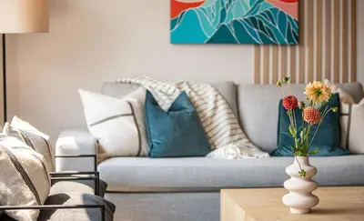 a living room with a couch and a vase with flowers on a table at Galena by Revelstoke Vacations in Revelstoke