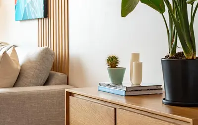 a living room with a table with plants and candles at Galena by Revelstoke Vacations in Revelstoke