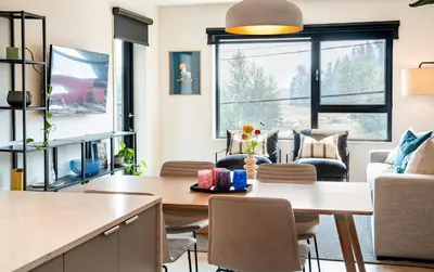 a kitchen and living room with a table and chairs at Galena by Revelstoke Vacations in Revelstoke