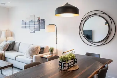 a living room with a table and a couch at Revylation by Revelstoke Vacations in Revelstoke