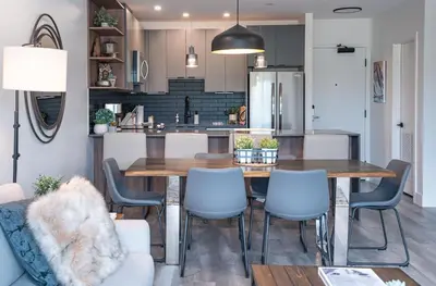 a kitchen and dining room with a table and chairs at Revylation by Revelstoke Vacations in Revelstoke