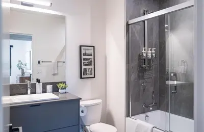 a bathroom with a shower and a toilet and a sink at Revylation by Revelstoke Vacations in Revelstoke