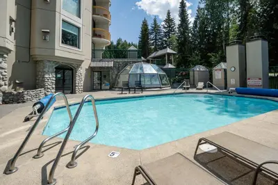 a large swimming pool in a resort building at 1BR in Marquise, Close to Ski Hill, Pool, Sauna, Hot Tub, Fitness Suite, Fireplace in Whistler