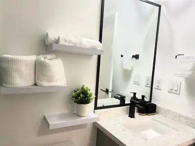 a bathroom with a sink and a mirror at Modern and New house near PNE with Big Garden and Free Parking in Vancouver