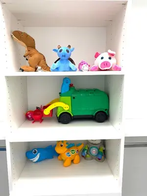 two shelves with different toys on them at Modern and New house near PNE with Big Garden and Free Parking in Vancouver
