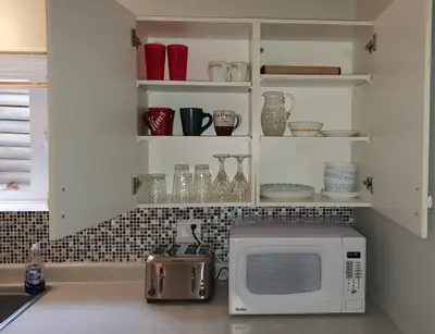 a kitchen with a microwave on a counter at Comfy KING Bed, Large private Basement Suite, Smart TV in Penticton- city of PEACHES AND BEACHES in Penticton