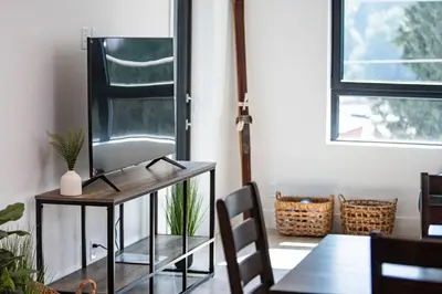 a dining room with a tv on a table at The Grizzly Basin by Revelstoke Vacations in Revelstoke