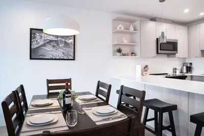 a kitchen and dining room with a table and chairs at The Grizzly Basin by Revelstoke Vacations in Revelstoke