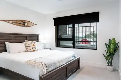 a bedroom with a large bed and a window at The Grizzly Basin by Revelstoke Vacations in Revelstoke