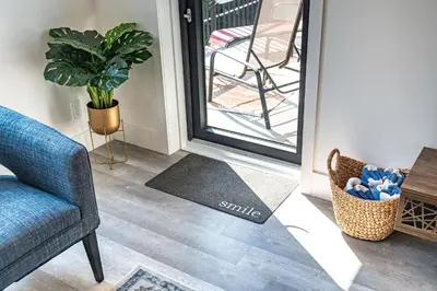 a living room with a blue chair and a plant at Rummy's Adventure Bay by Revelstoke Vacations in Revelstoke