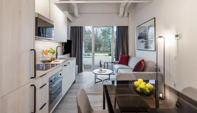 a living room with a couch and a table at Steveston Waterfront Hotel in Richmond