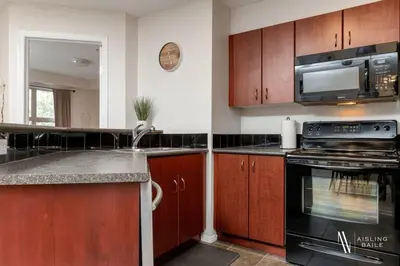 a kitchen with a stove and a microwave at Light N Airy, Pool, Hot Tub, Pets, Ground Floor in Invermere
