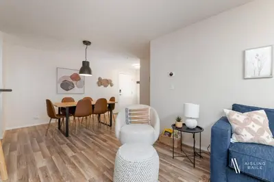a living room with a table and a blue couch at Light N Airy, Pool, Hot Tub, Pets, Ground Floor in Invermere