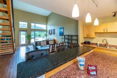 a kitchen and living room with a counter and a living room at NN - The Loft - Downtown 1-bed 2-bath in Whitehorse