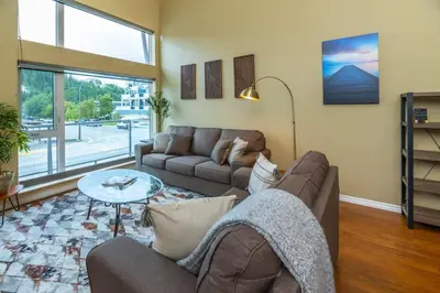 a living room with a couch and a table at NN - The Loft - Downtown 1-bed 2-bath in Whitehorse
