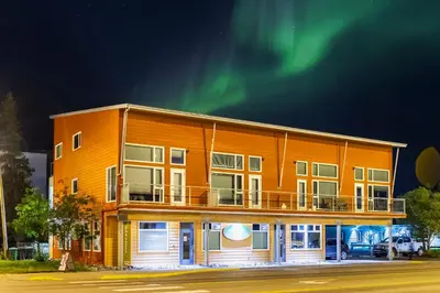 an apartment building with the northern lights in the sky at NN - The Loft - Downtown 1-bed 2-bath in Whitehorse