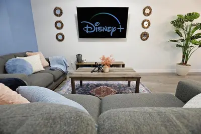 a living room with couches and a coffee table at Beautiful 3 King Beds,Garage,Airport,Disney+ in Edmonton