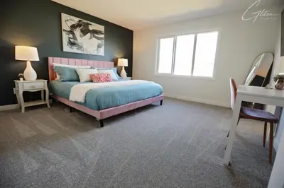a bedroom with a bed and a desk and a window at Beautiful 3 King Beds,Garage,Airport,Disney+ in Edmonton