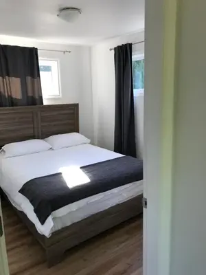 a bedroom with a bed with a black and white blanket at Jewel Bay Resort in Sorrento